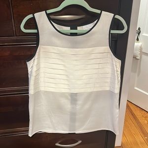 White with black detail sleeveless blouse. New condition. Size S